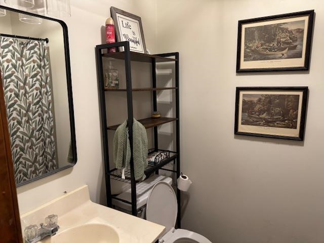 525 Middleton Loop Bolivar, TN 38008 - Photo 13 of 13 a bathroom with a toilet sink and mirror