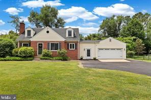 4630 Muncaster Mill Road Rockville, MD 20853 - Photo 1 of 40 a view of a white house next to a yard with potted plants