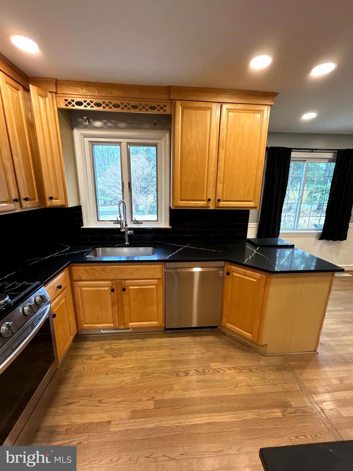 4630 Muncaster Mill Road Rockville, MD 20853 - Photo 11 of 40 a kitchen with granite countertop a stove and a sink