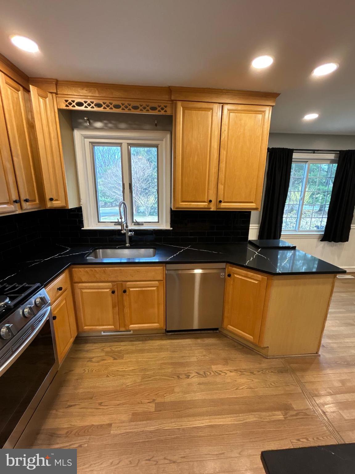 4630 Muncaster Mill Road Rockville, MD 20853 - Photo 13 of 40 a kitchen with granite countertop a stove a sink and a microwave