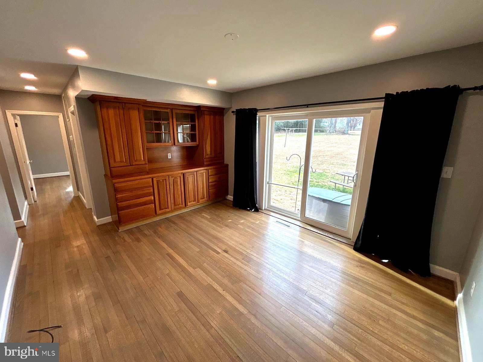 4630 Muncaster Mill Road Rockville, MD 20853 - Photo 16 of 40 an empty room with wooden floor and windows