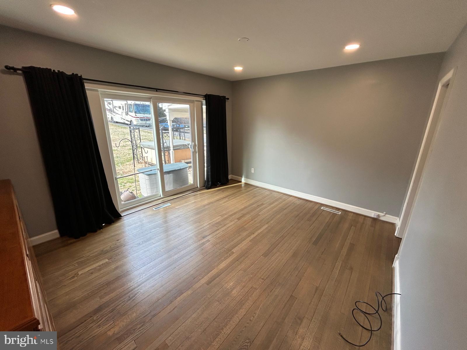 4630 Muncaster Mill Road Rockville, MD 20853 - Photo 17 of 40 an empty room with wooden floor and windows