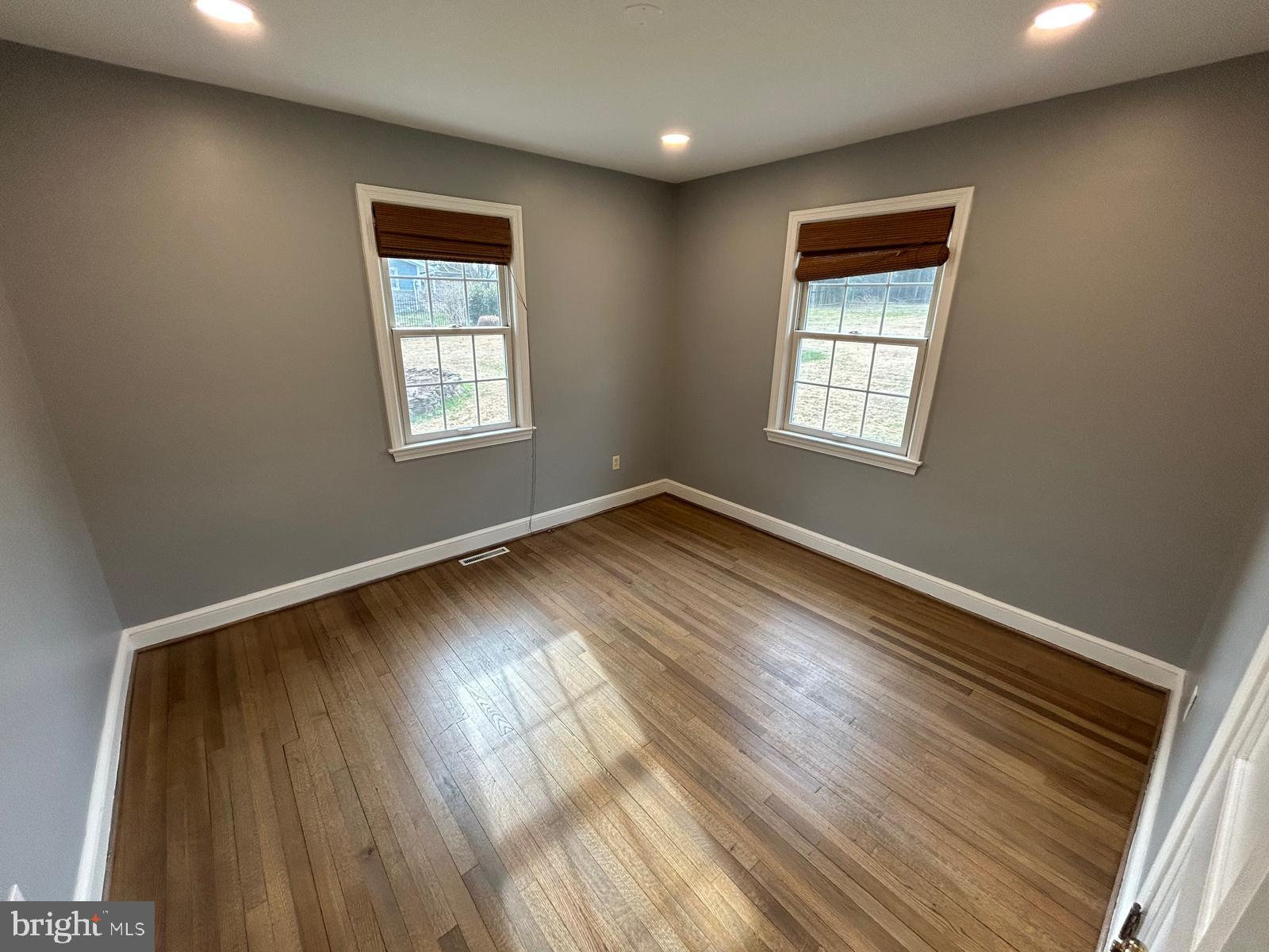4630 Muncaster Mill Road Rockville, MD 20853 - Photo 18 of 40 an empty room with wooden floor and windows