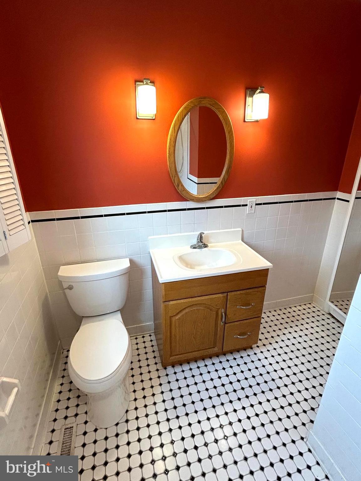 4630 Muncaster Mill Road Rockville, MD 20853 - Photo 20 of 40 a bathroom with a sink mirror vanity and toilet