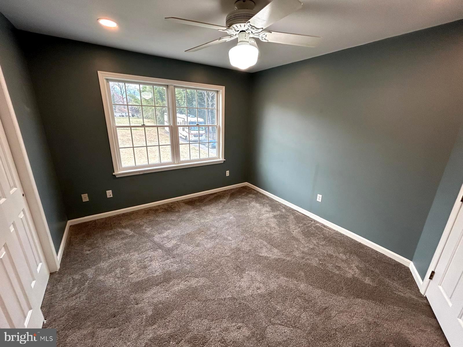 4630 Muncaster Mill Road Rockville, MD 20853 - Photo 22 of 40 en empty room with windows and ceiling fan