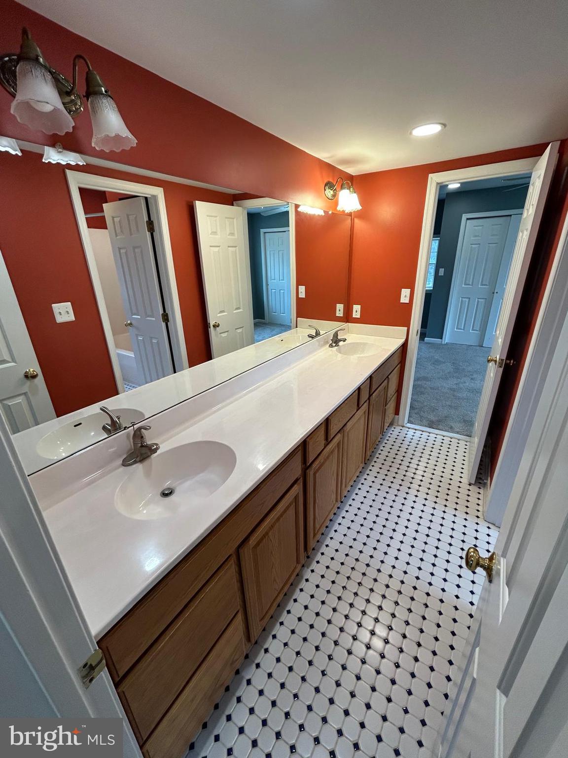 4630 Muncaster Mill Road Rockville, MD 20853 - Photo 27 of 40 a spacious bathroom with a double vanity sink and a mirror