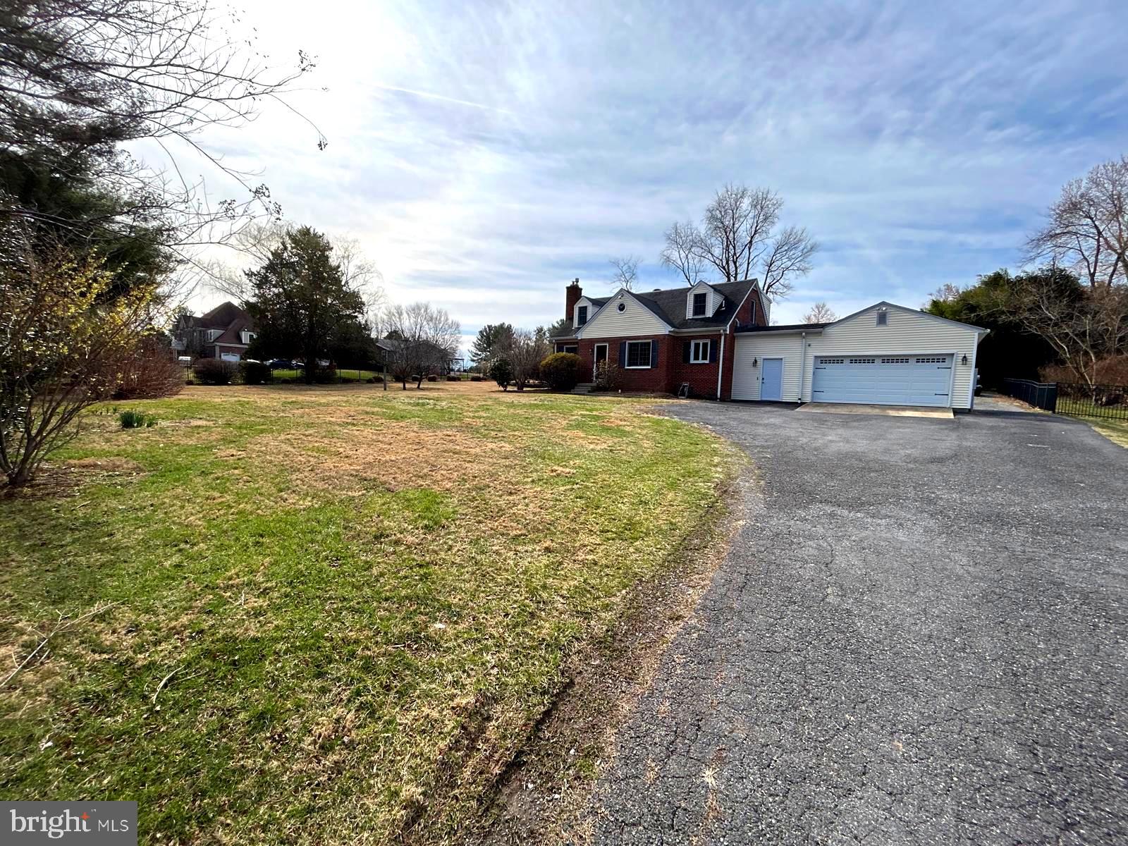 4630 Muncaster Mill Road Rockville, MD 20853 - Photo 3 of 40 a view of a big yard with potted plants and large trees