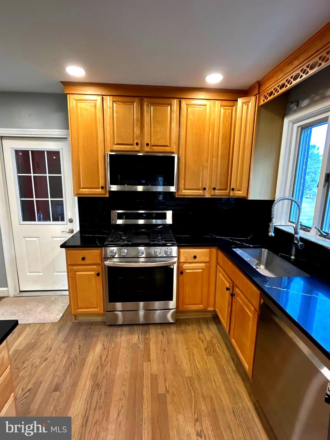 4630 Muncaster Mill Road Rockville, MD 20853 - Photo 9 of 40 a kitchen with a stove a sink and a microwave