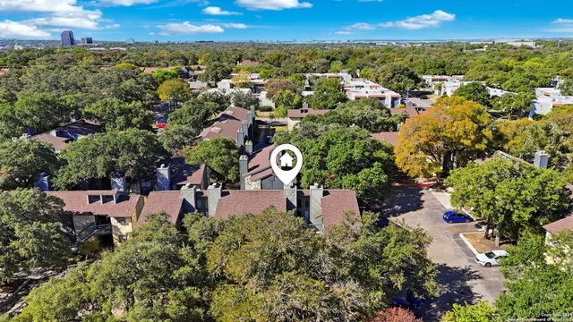 an aerial view of a house with a yard and lake view