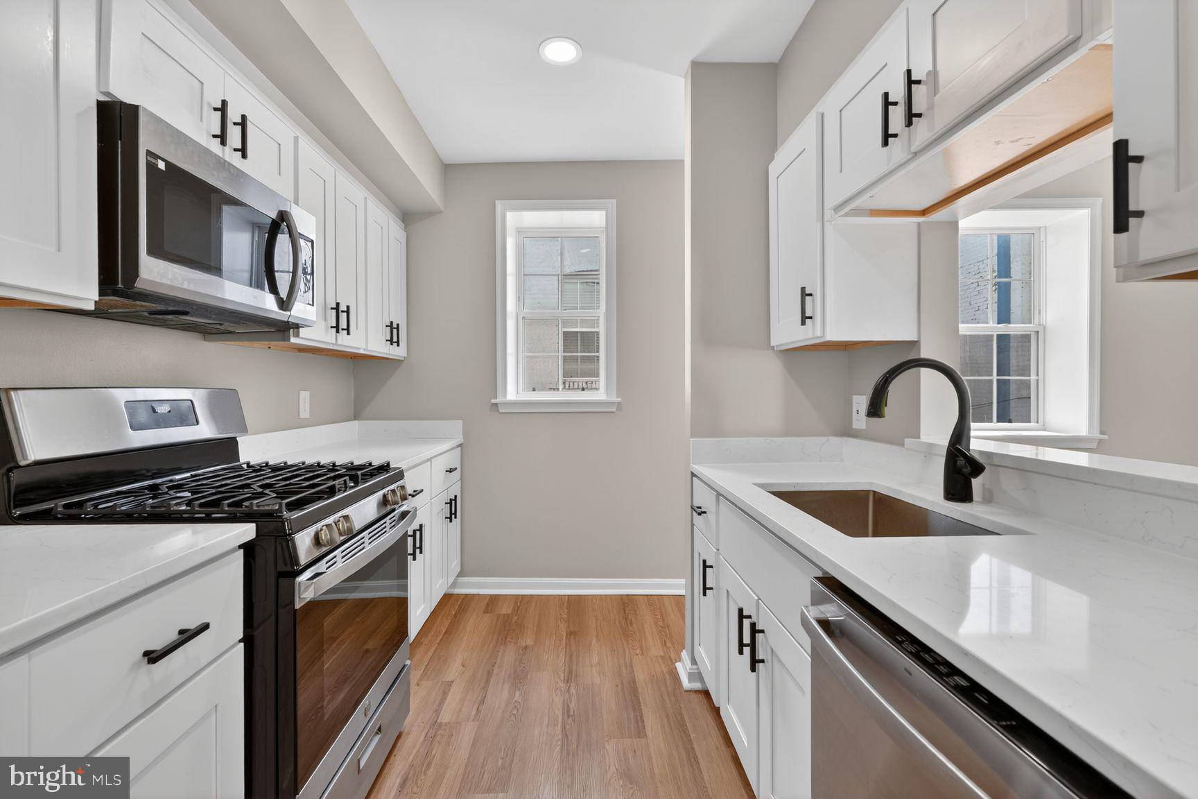 1008 Rittenhouse Street Northwest, Unit 15 Washington, DC 20011 - Photo 8 of 39 a kitchen with stainless steel appliances granite countertop a sink stove and cabinets