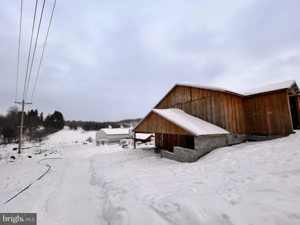a view of a house with a snow in the yard