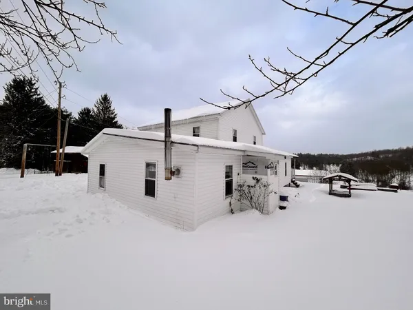 a view of a house with a snow in the background