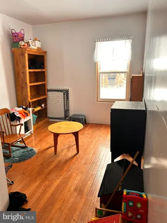 a living room with furniture rug and a chandelier