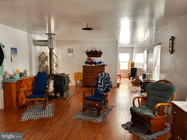 a living room with furniture gym equipment and a large window