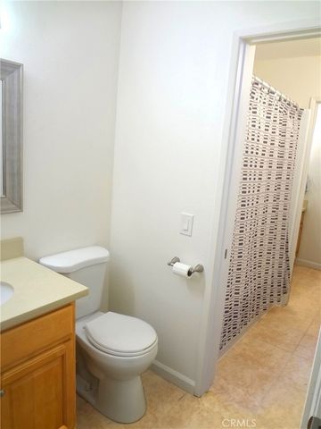 a white toilet sitting next to a shower curtain