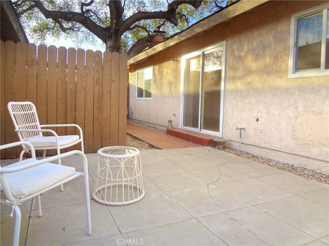 a backyard of a house with table and chairs