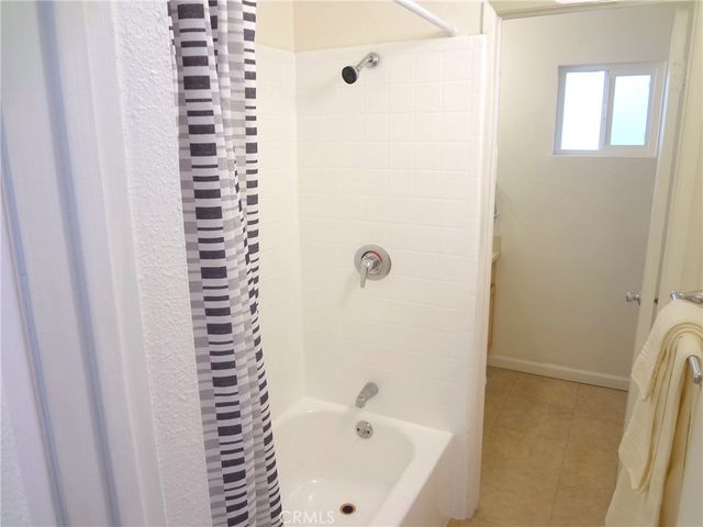 a bathroom with a bathtub and shower