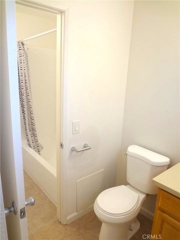 a white toilet sitting next to a shower