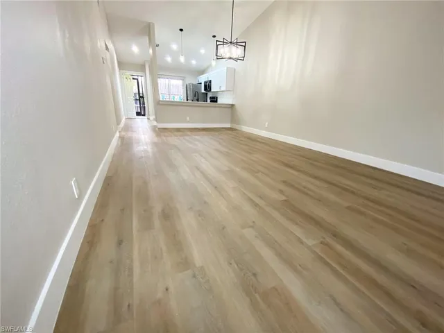 a view of a kitchen with wooden floor