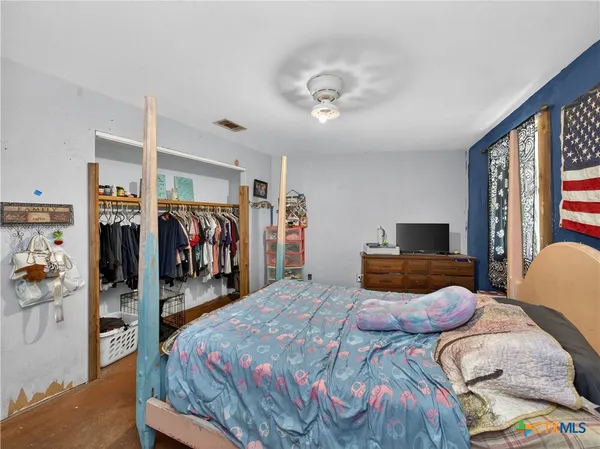 a bedroom with furniture and a window