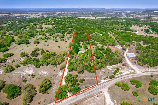 a view of a patio with table and chairs potted plants with wooden floor and fence