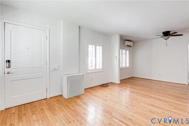 wooden floor in an empty room with a window