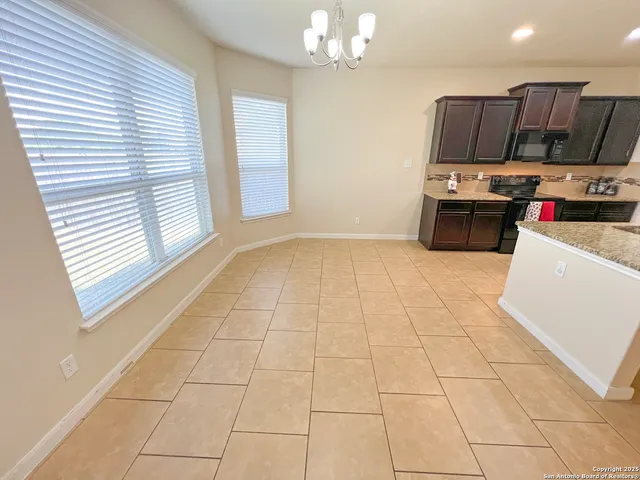 a kitchen with stainless steel appliances a stove a sink and a microwave