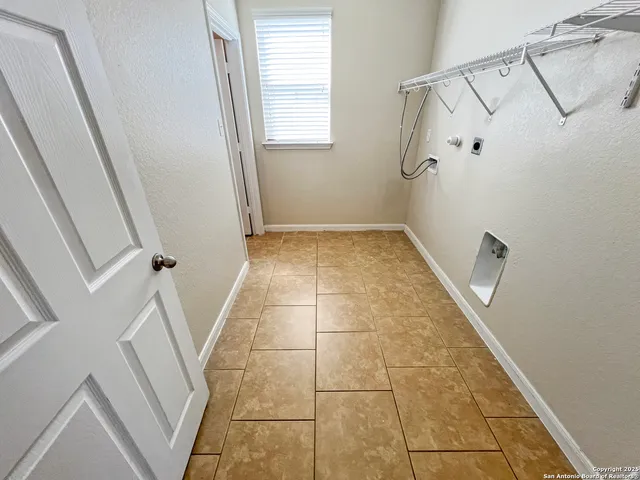 a view of a bathroom with white walls