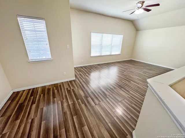 an empty room with a empty space and windows