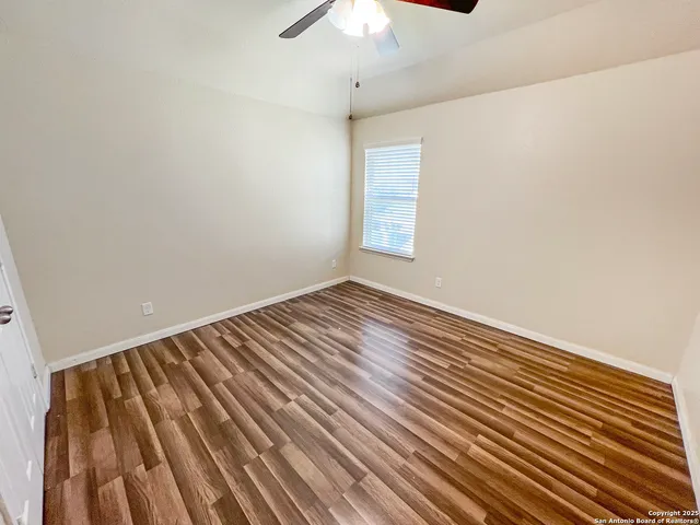 a view of a room with wooden floor