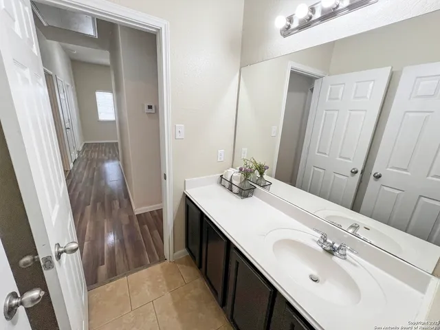 a spacious bedroom with a bed and a chandelier