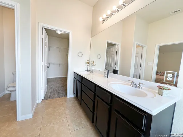a bathroom with a sink a mirror and a shower