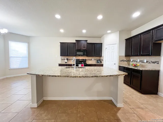 a kitchen with stainless steel appliances granite countertop a sink counter space and cabinets