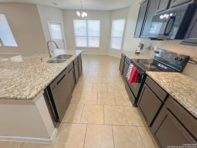 a bathroom with a granite countertop sink a mirror and a bathtub