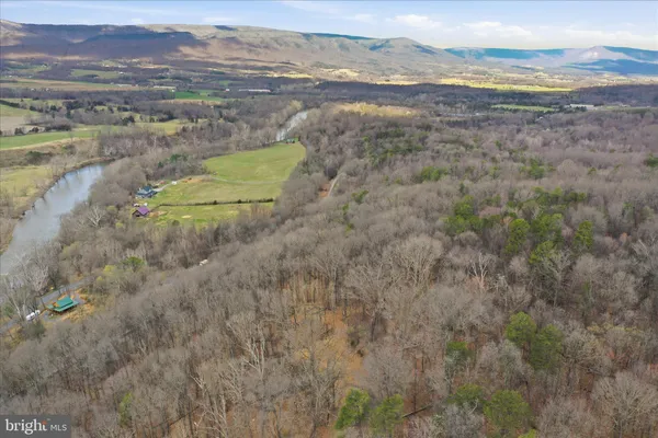 a view of a dry yard with mountains in the background