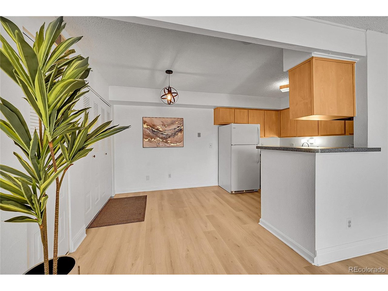 Undisclosed Address Wheat Ridge, CO 80033 - Photo 6 of 21 a view of a kitchen with a sink and a microwave