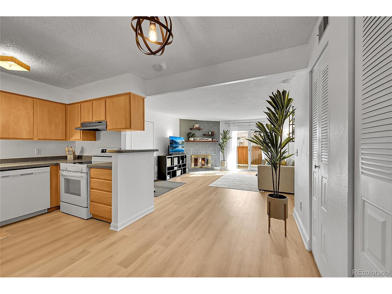 Undisclosed Address Wheat Ridge, CO 80033 - Photo 7 of 21 a kitchen with a refrigerator and a stove top oven