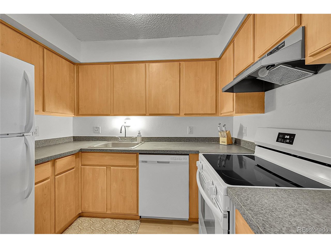 Undisclosed Address Wheat Ridge, CO 80033 - Photo 9 of 21 a kitchen with stainless steel appliances granite countertop a sink a stove and a microwave