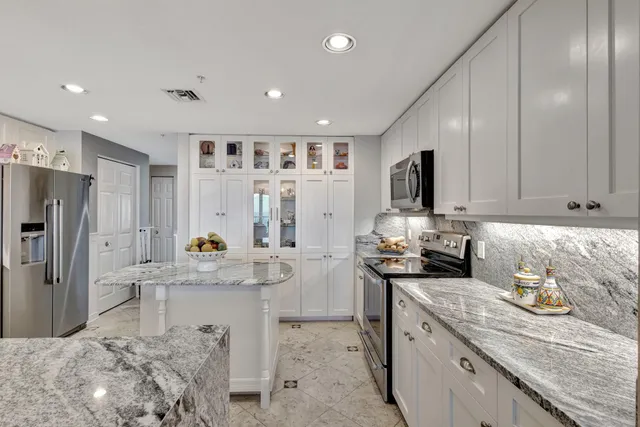 a kitchen with refrigerator and cabinets
