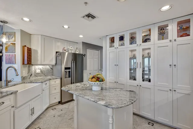 a kitchen with stainless steel appliances granite countertop a sink and cabinets
