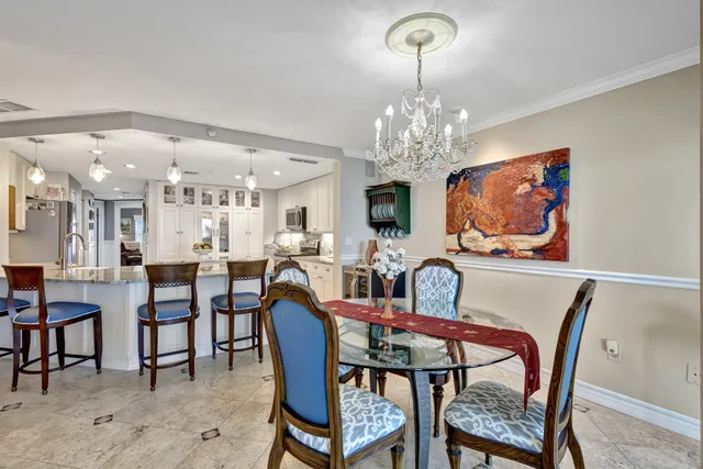 a view of a dining room with furniture and chandelier