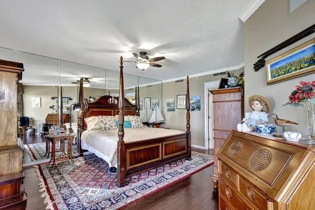 a bedroom with a bed table and chairs