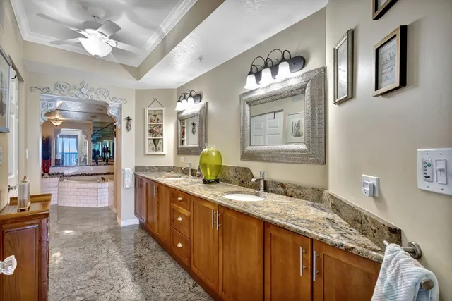 a spacious en suite bathroom with double vanity and a mirror