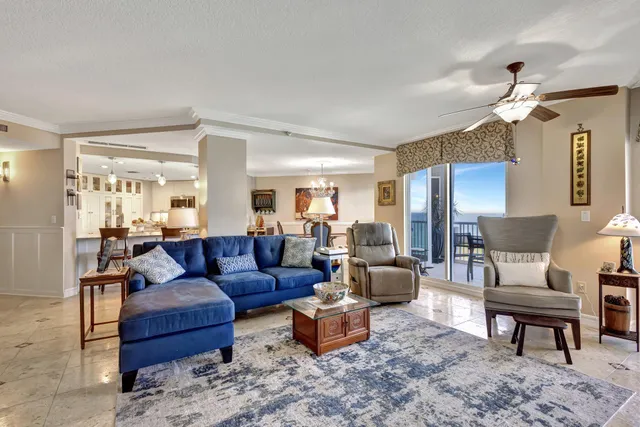 a living room with furniture wooden floor and chandelier