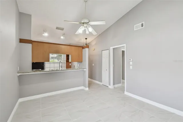 a view of kitchen with refrigerator and window