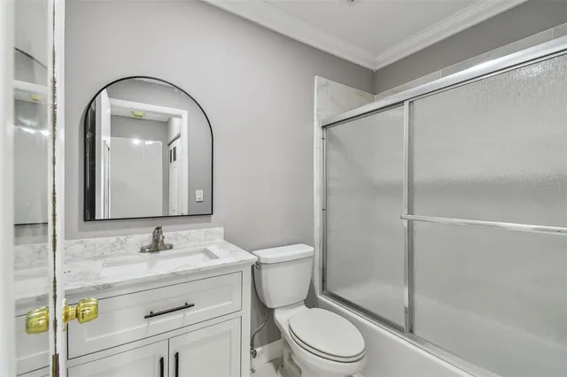 a bathroom with a toilet a sink a mirror and a shower