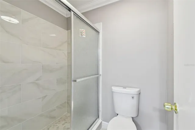 a bathroom with a toilet and a shower
