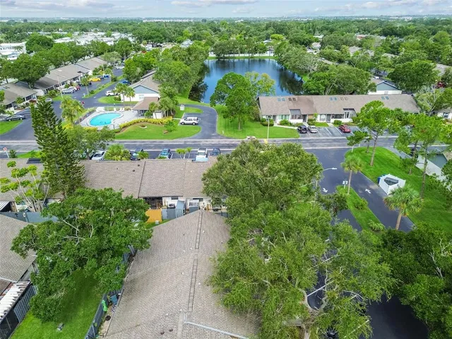 an aerial view of a house with a garden and lake view