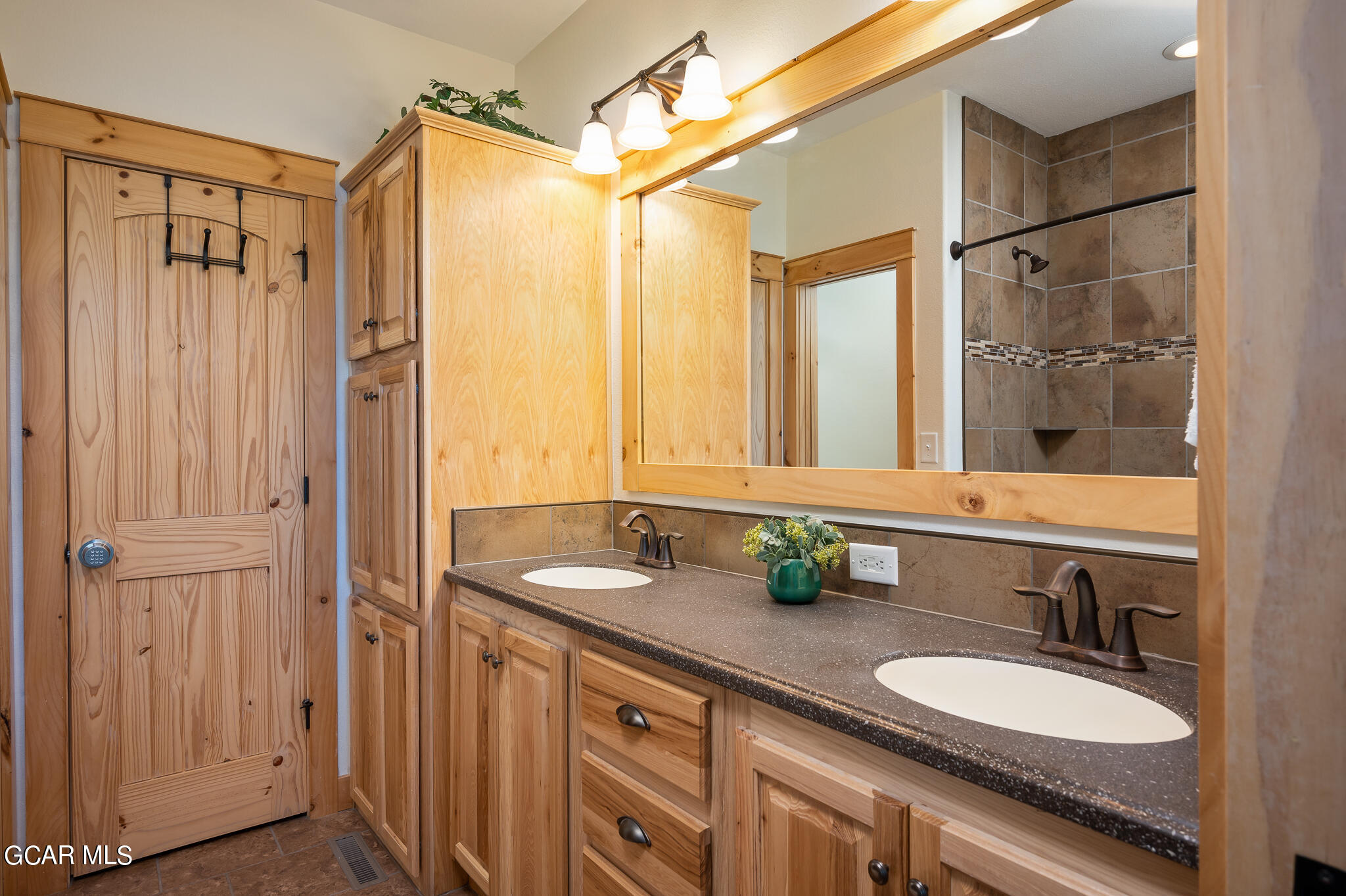 107 Edgewater Circle Granby, CO 80446 - Photo 27 of 51 a bathroom with a granite countertop sink mirror and a shower