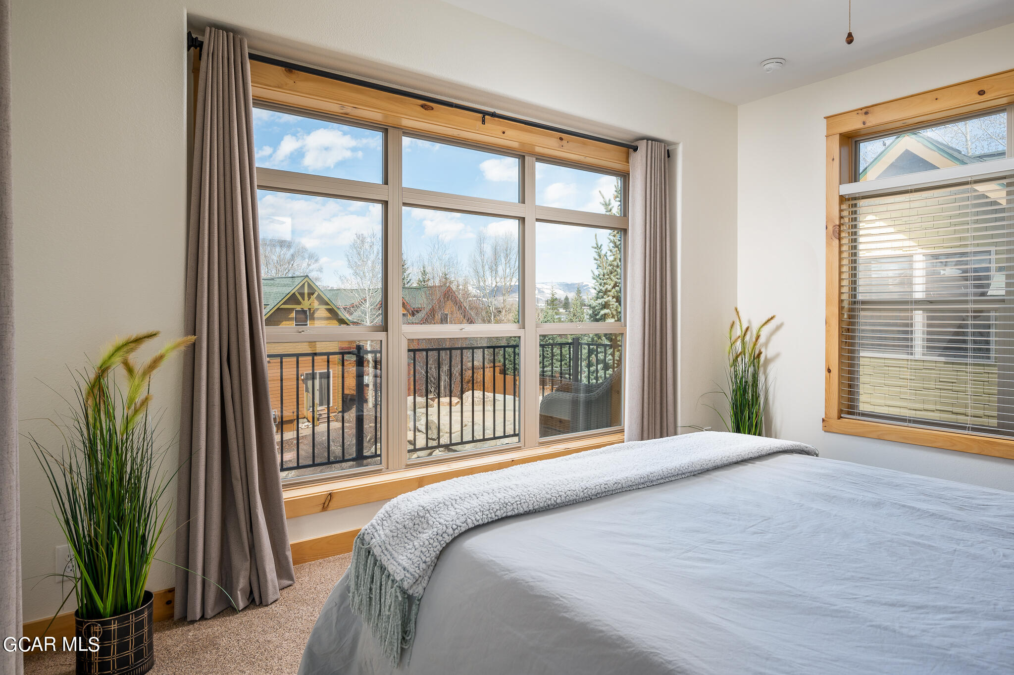 107 Edgewater Circle Granby, CO 80446 - Photo 29 of 51 a bedroom with a balcony a bed and a large window